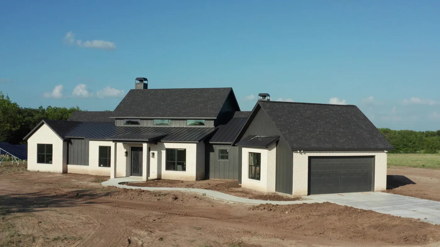 Newly completed Ark Industries custom home at final grade, days before landscaping
